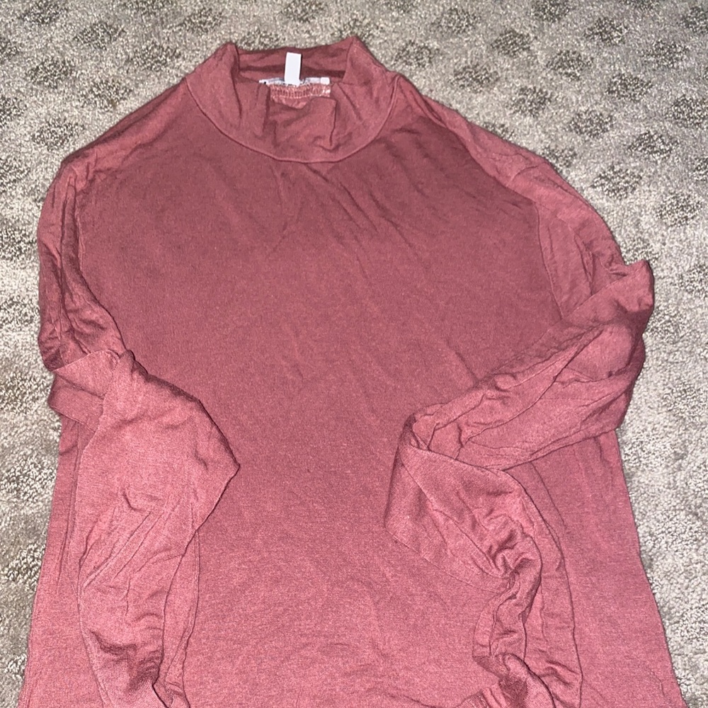 A burnt pink turtle neck crop long sleeve